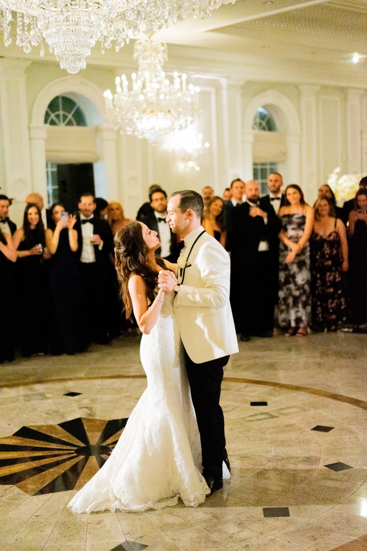 Christopher and Stephanie's first dance beneath crystal chandeliers